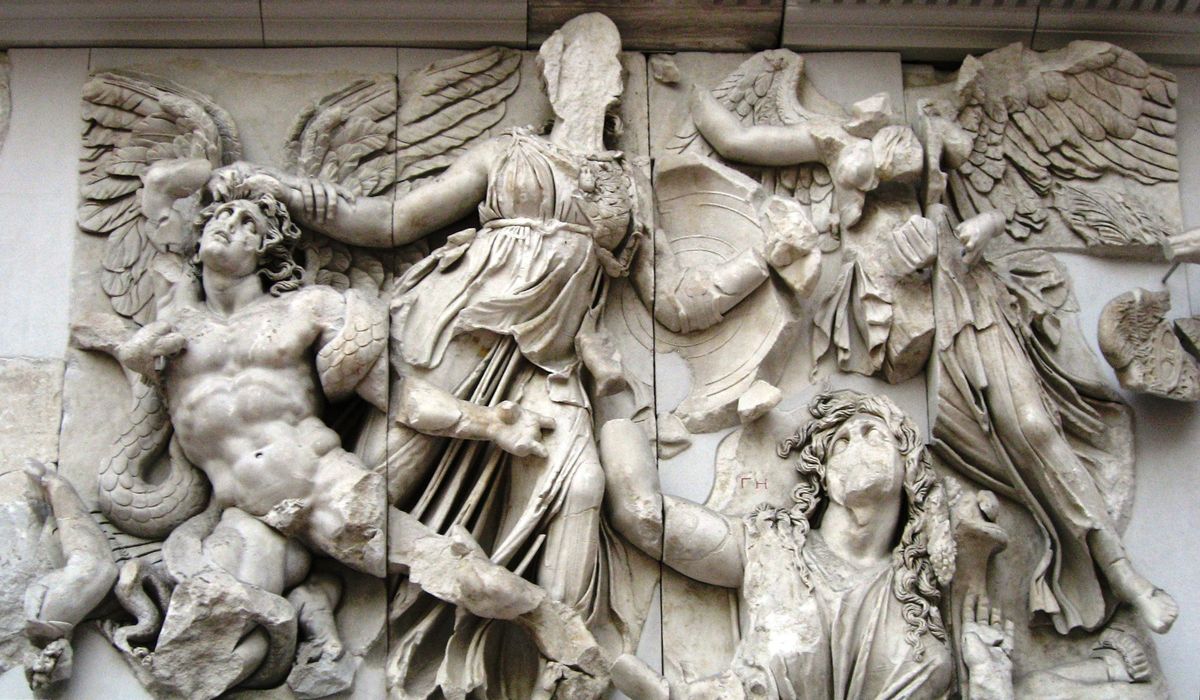 Athena grips the winged giant Alkyoneus by the hair while Gaia, the Earth, rises beside them, on the Gigantomachy frieze of the Pergamon Altar