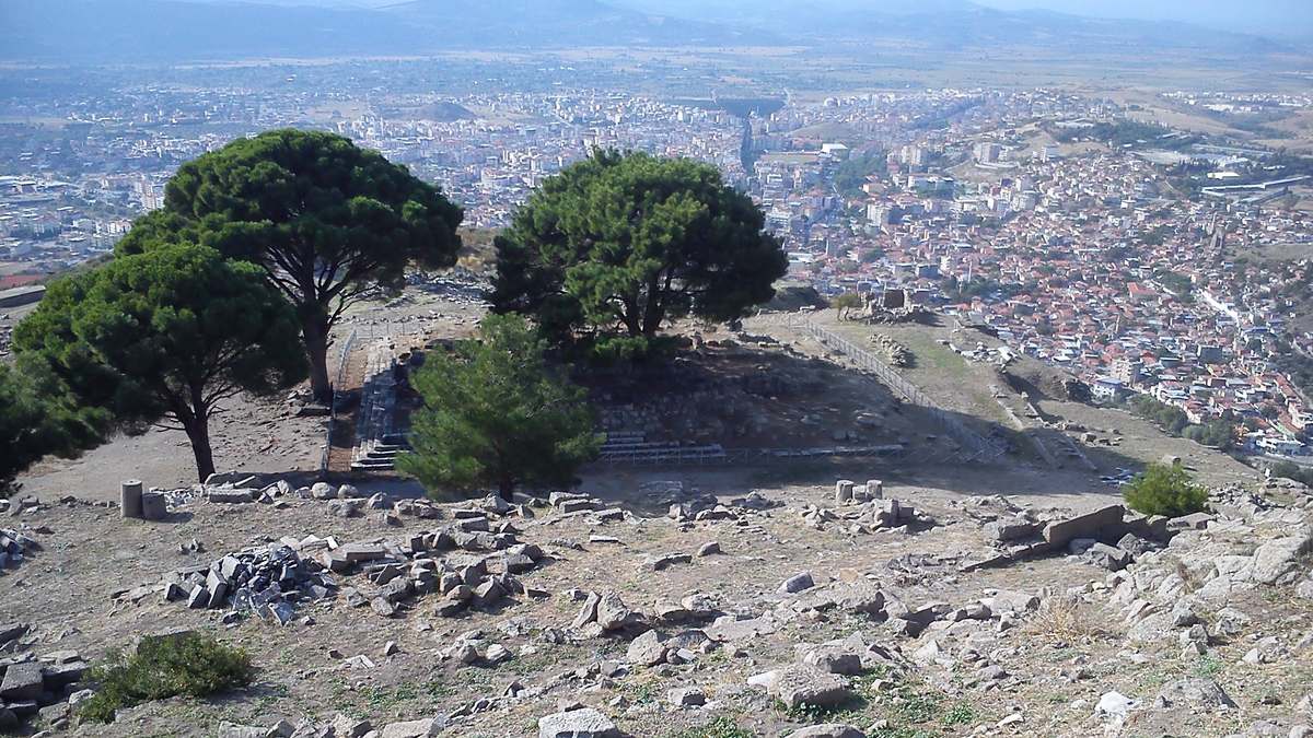 The empty altar terrace on the Pergamon acropolis: the stepped foundation under its pine trees, with Bergama and its plain below
